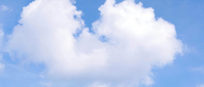 pexels-photo-33397171-33397171 A fluffy, heart-shaped cloud set against a bright blue sky, symbolizing love and nature.